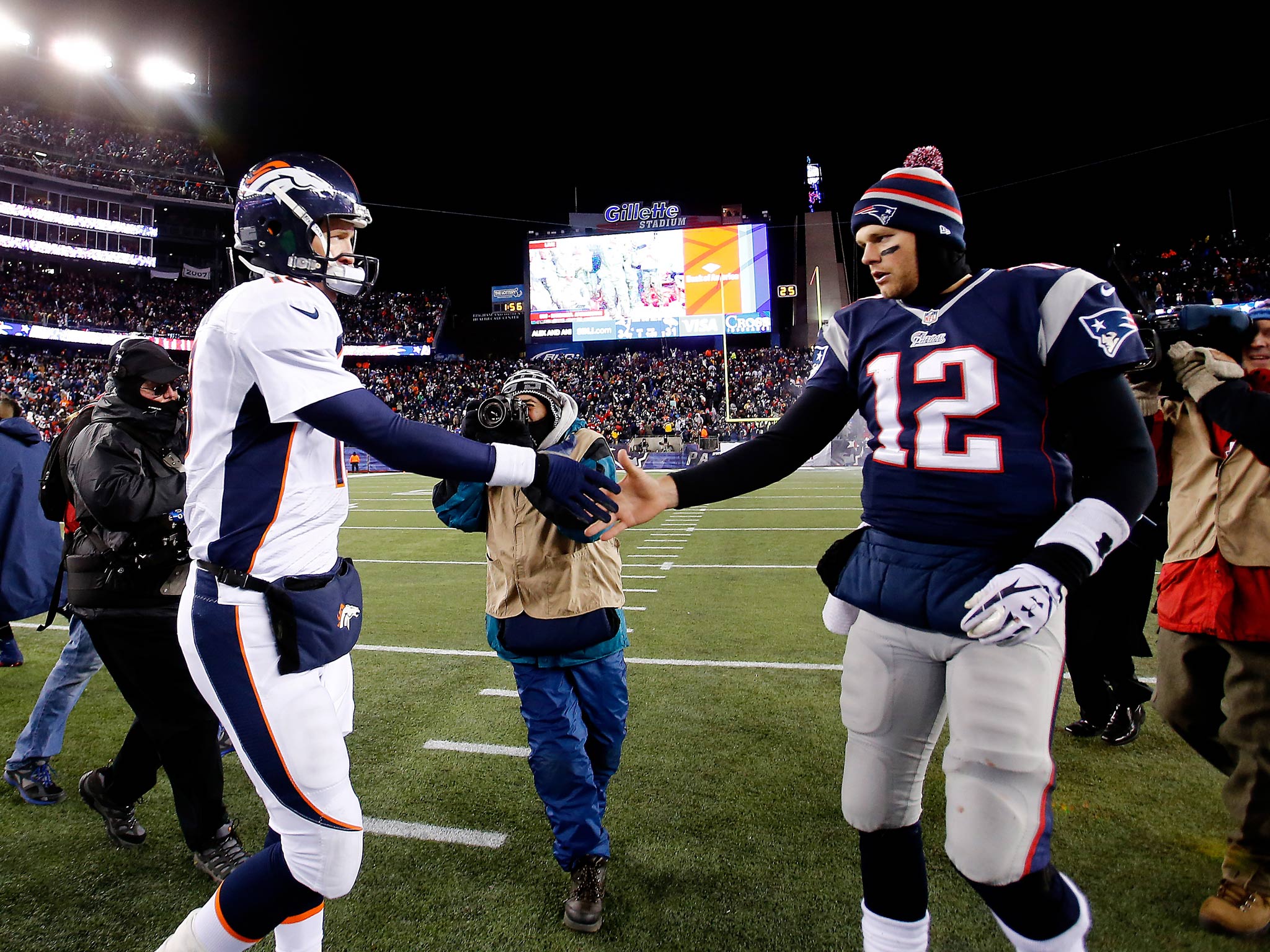 Quarterback Peyton Manning #18 of the Denver Broncos and quarterback Tom Brady #12 of the New England Patriots