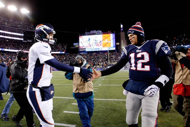 Quarterback Peyton Manning #18 of the Denver Broncos and quarterback Tom Brady #12 of the New England Patriots 