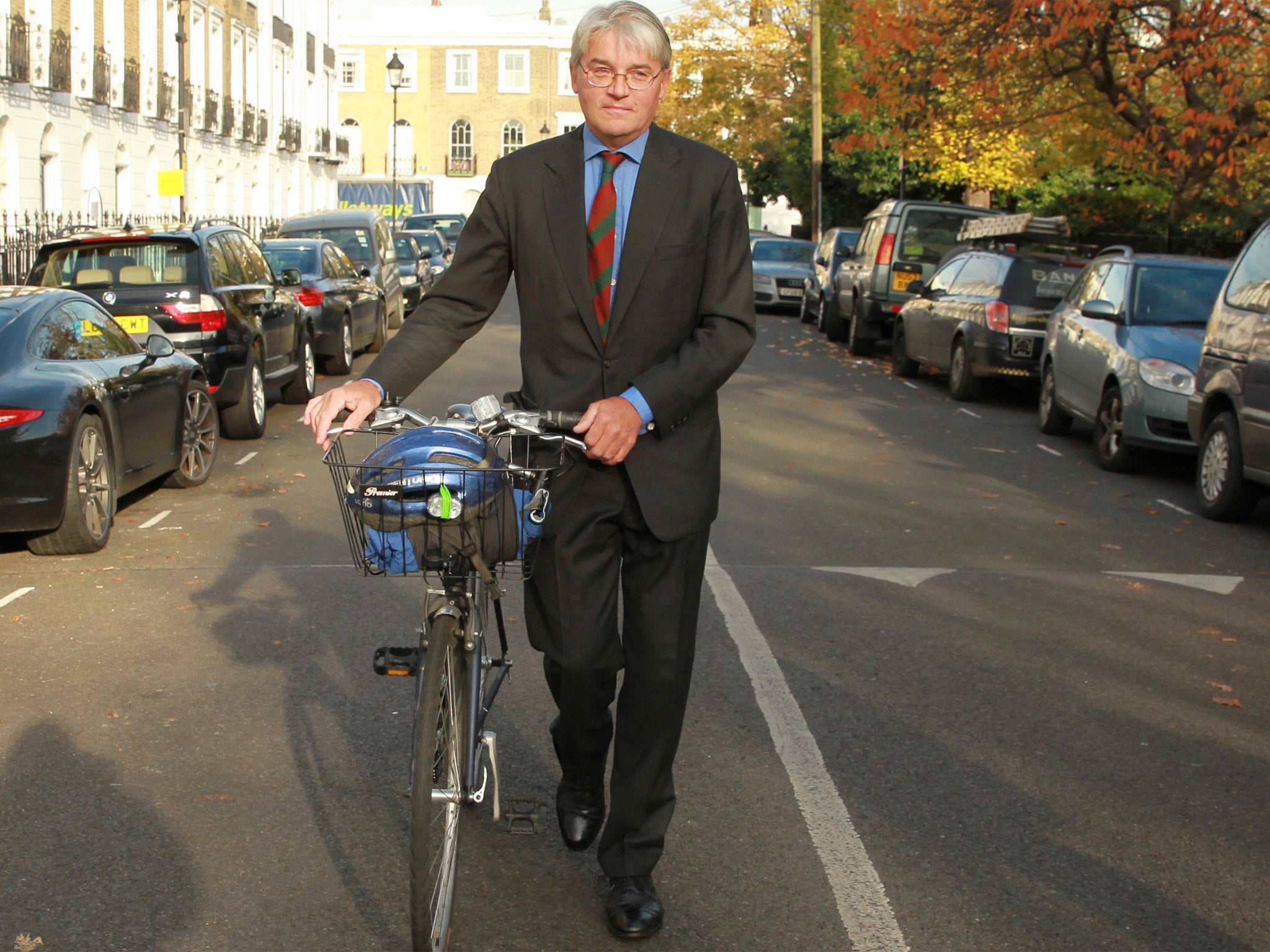 Andrew Mitchell, with his bike, outside his home in north London
