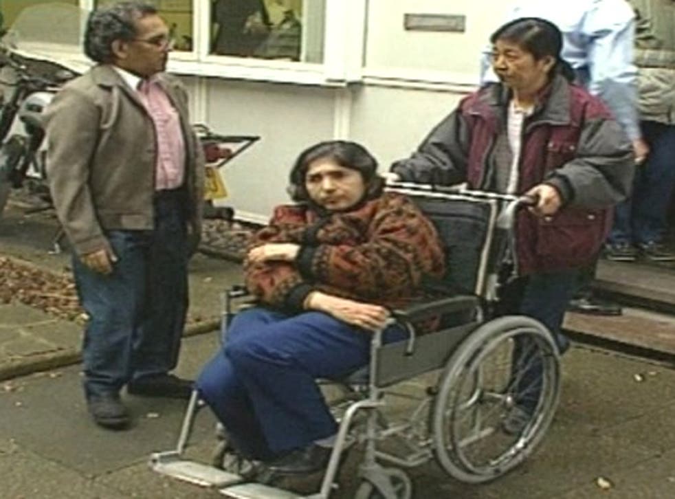 Aravindan Balakrishnan and his wife Chanda, in wheelchair, at an inquest into the death of commune member Sian Davies
