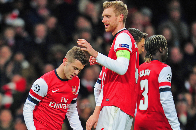Jack and the beanstalk: Wilshere is congratulated by Mertesacker