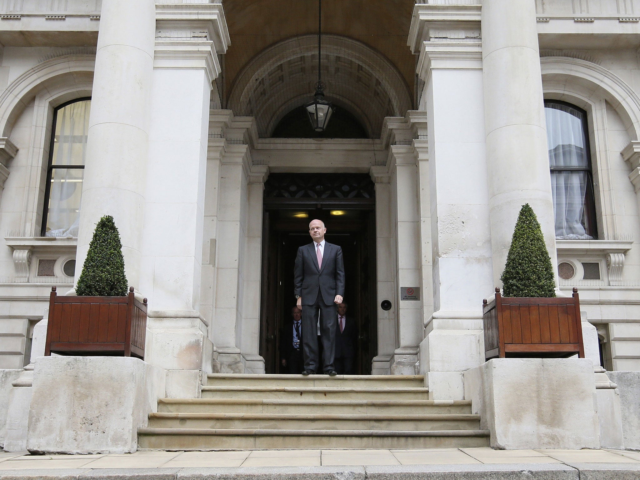 Foreign Secretary William Hague stands on the steps of the Foreign and Commonwealth Office headquarters in London