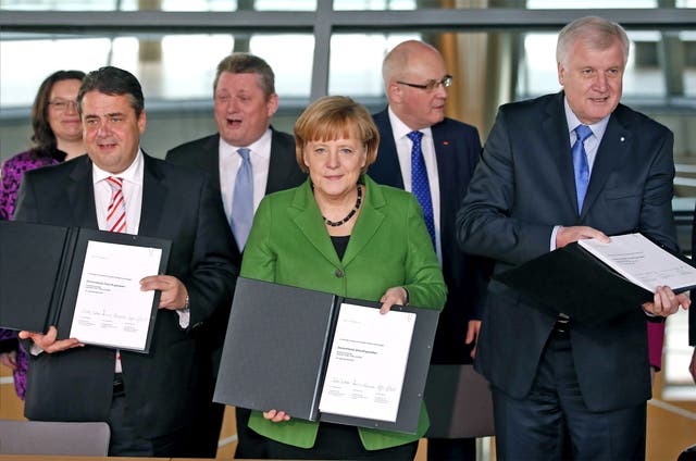 Angela Merkel, centre, made concessions on pensions and the labour market but not on eurozone policy