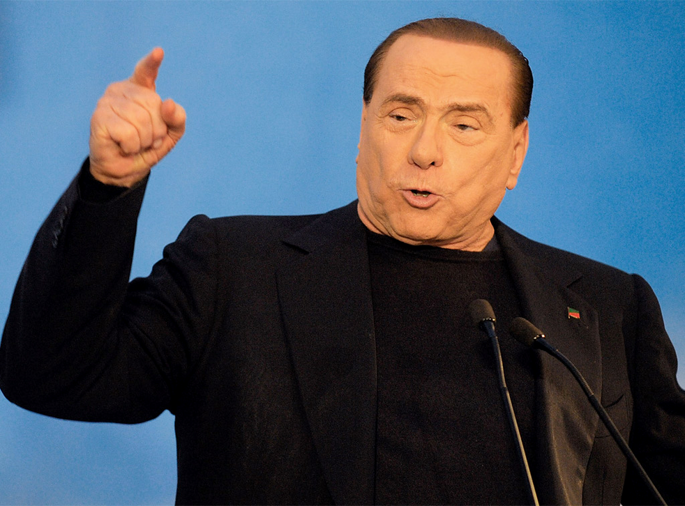 Berlusconi delivers a speech at a rally in front of his Roman palazzo
