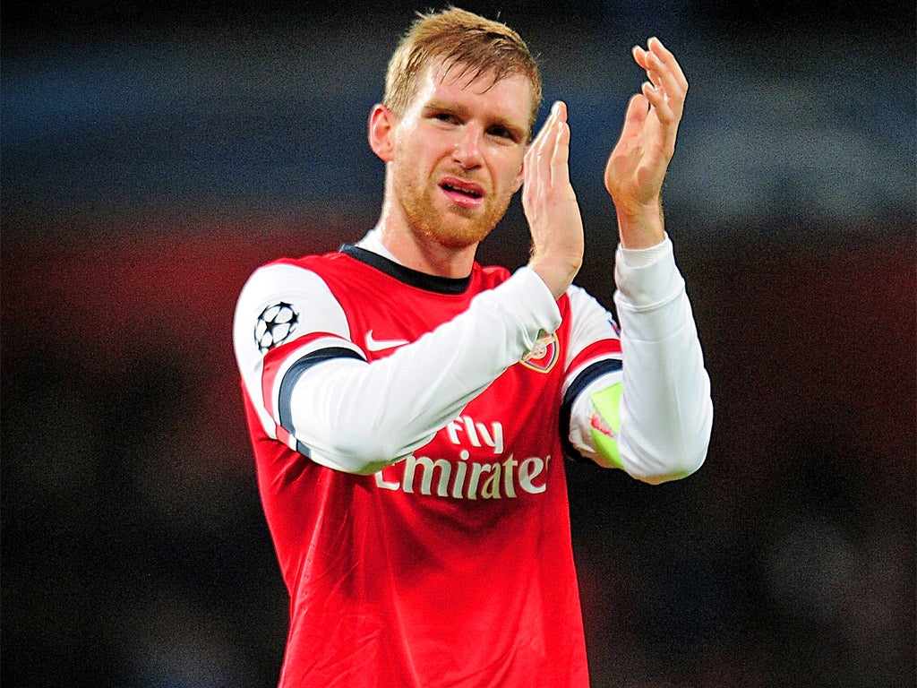 Per Mertesacker applauds the fans after Arsenal’s Champions League win over Marseilles on Tuesday