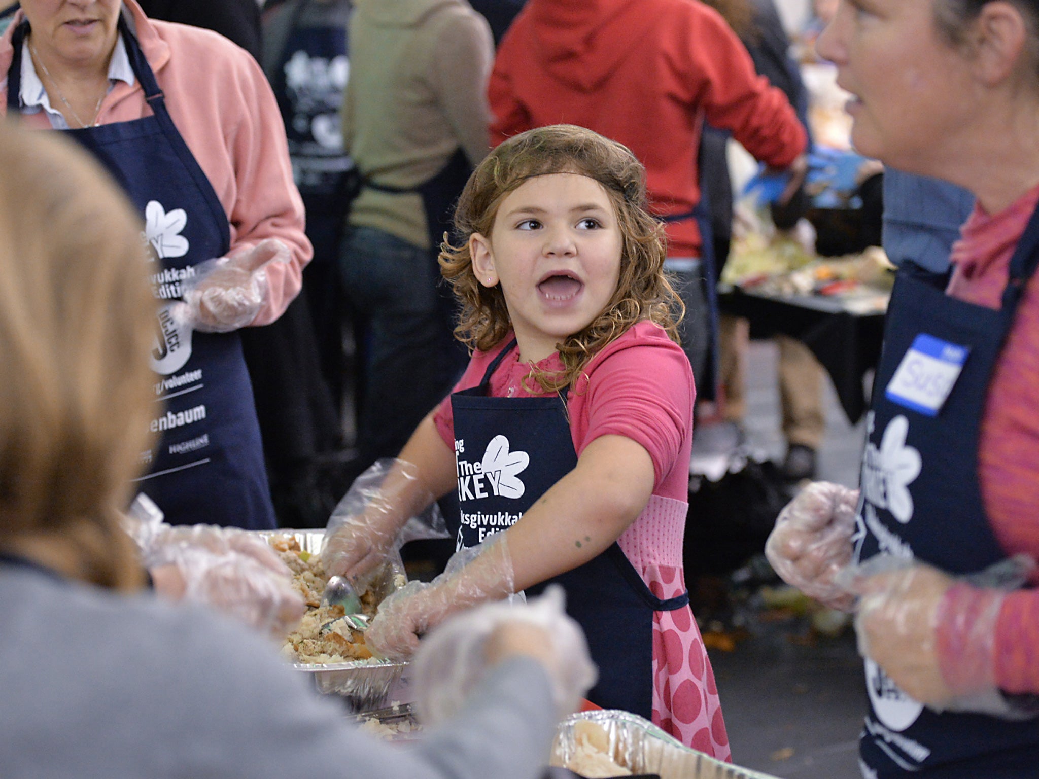 People prepare Thanksgiving meals for those in need at the District of Columbia Jewish Community Center in Washington as America prepares to celebrate Thanksgiving in its rare overlap with the Jewish holiday of Hanukkah, prompting the center to dub it 'Th