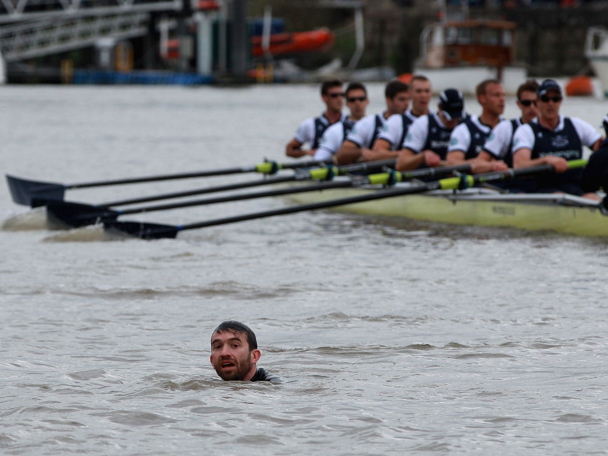 The Oxford crew look on as protester Trenton Oldfield swims in the water in April 2012 (Getty)