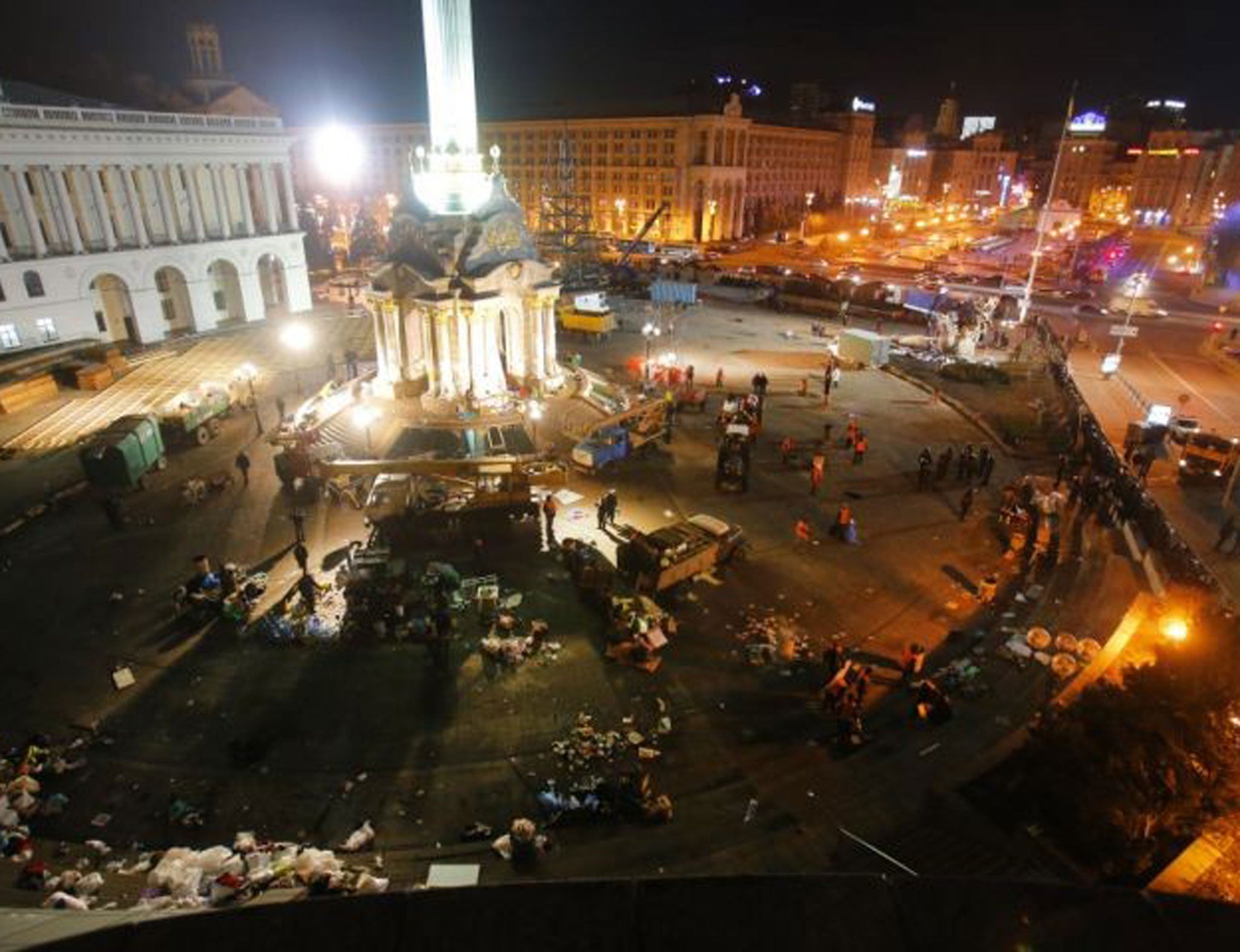 Government workers clean up after the violent scenes