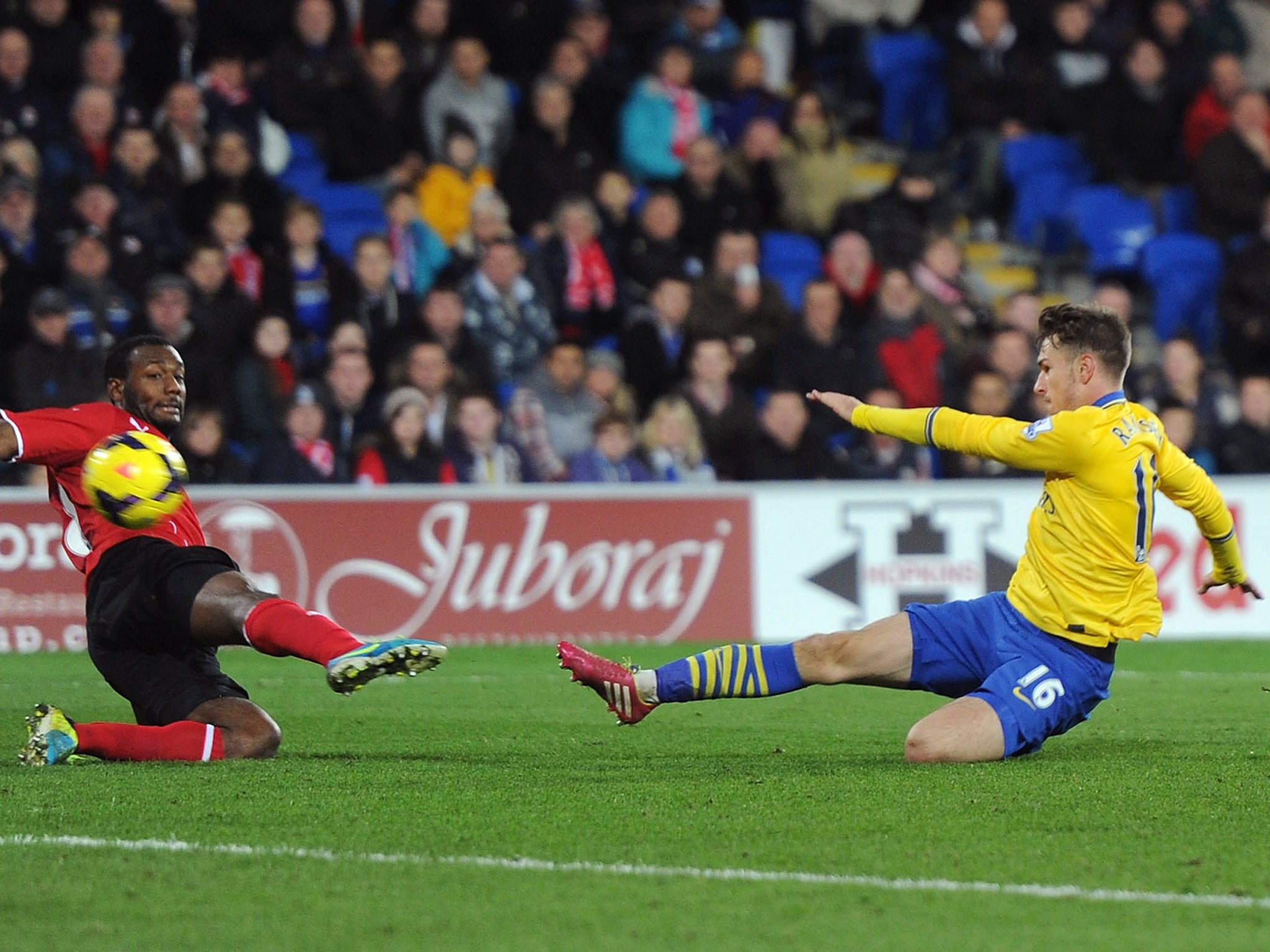 Aaron Ramsey slides in to score his second and Arsenal's third in injury time against Cardiff