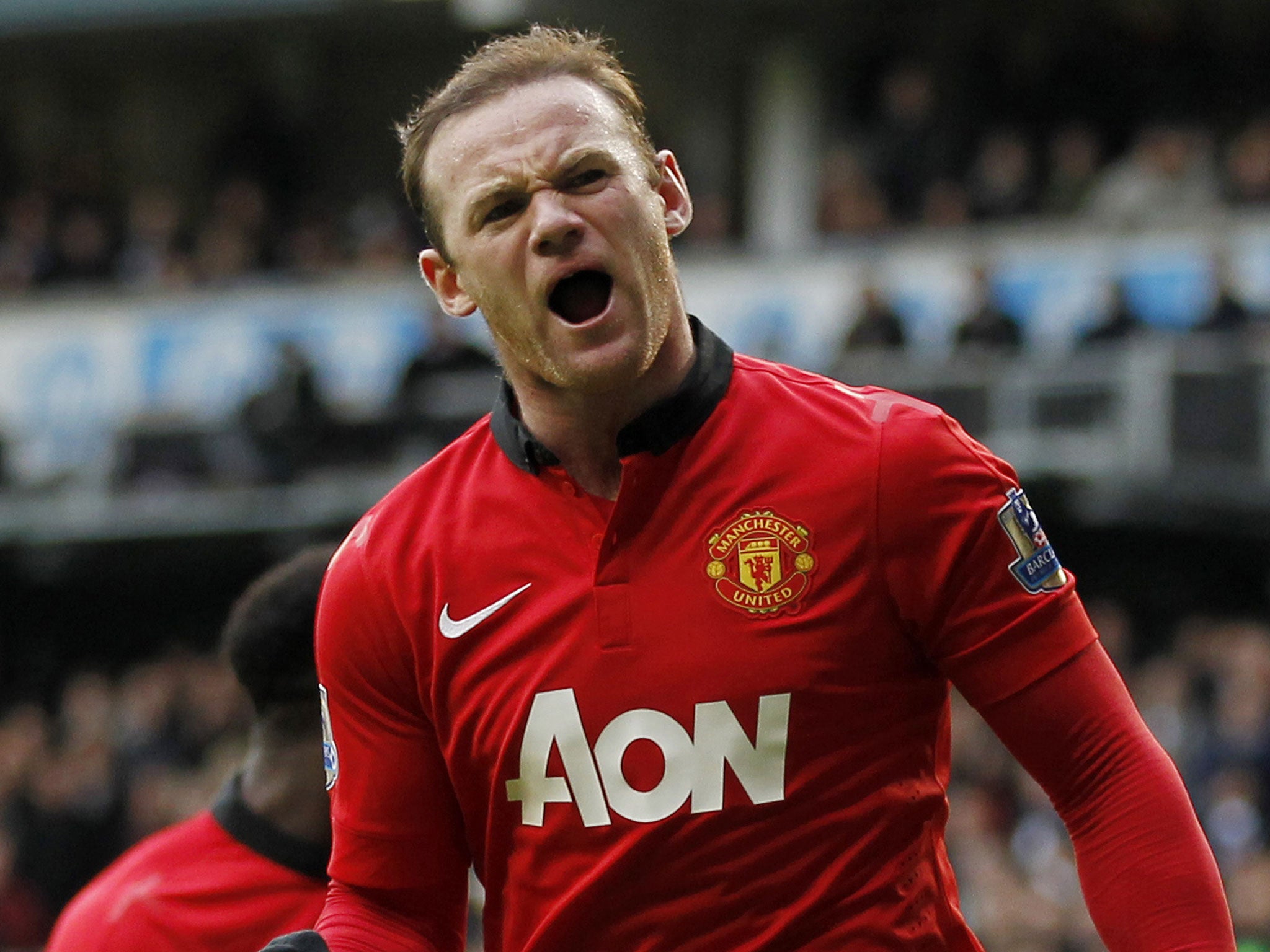 Wayne Rooney celebrates scoring his second from the penalty spot against Tottenham