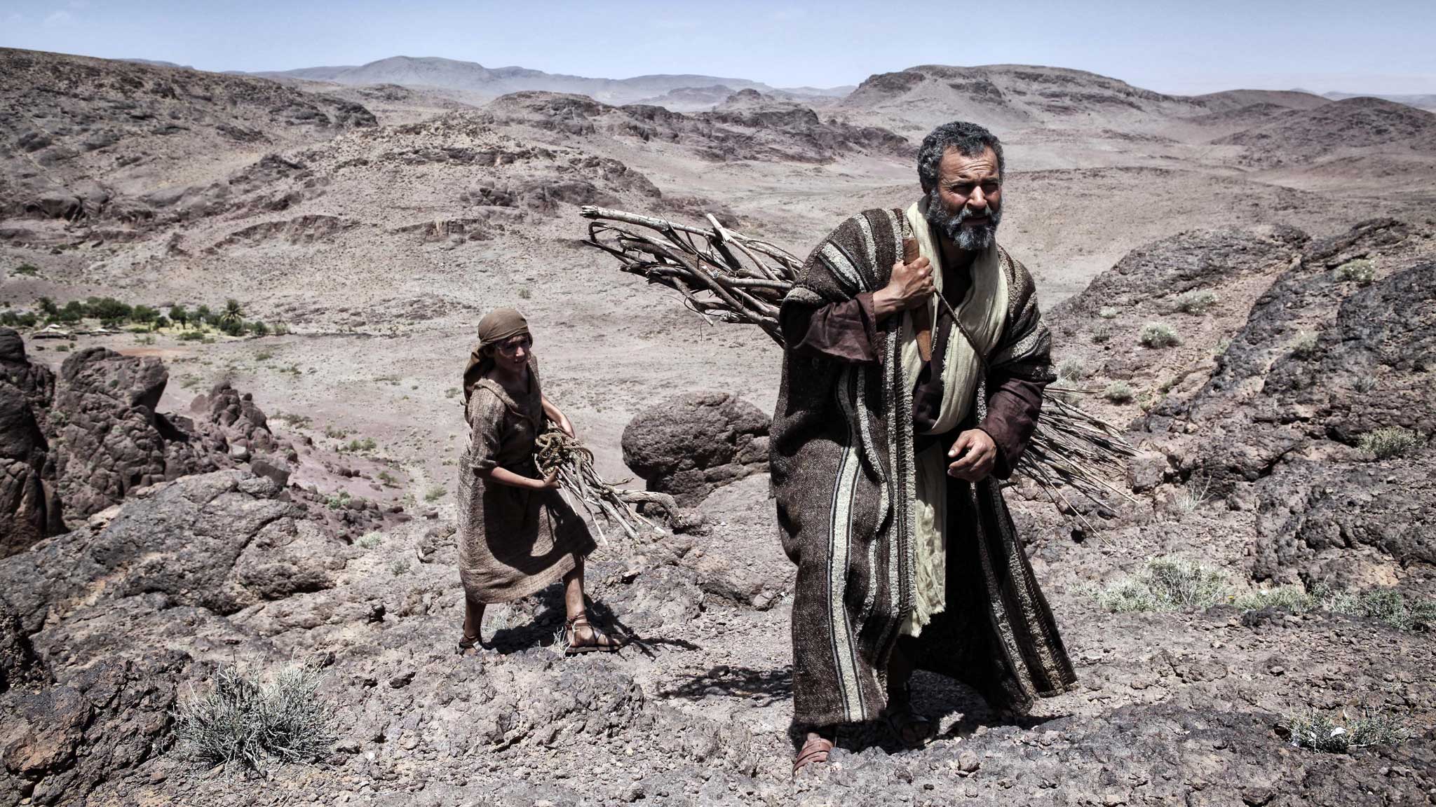 Abraham (Gary Oliver) prepares Isaac (Hugo Rossi) for the sacrifice in The Bible