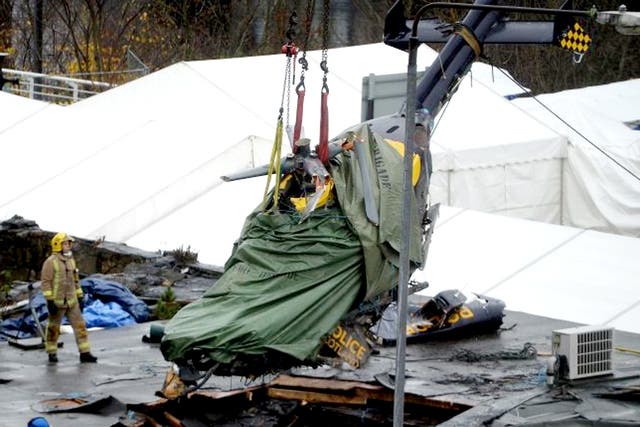 The police helicopter wreckage being lifted from the roof of the The Clutha Pub in Glasgow, Scotland