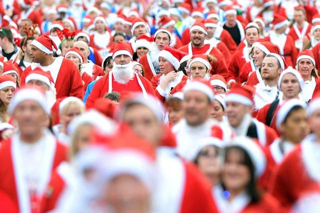 Runners dressed in Father Christmas costumes take part in the annual 5km Santa Dash in Liverpool