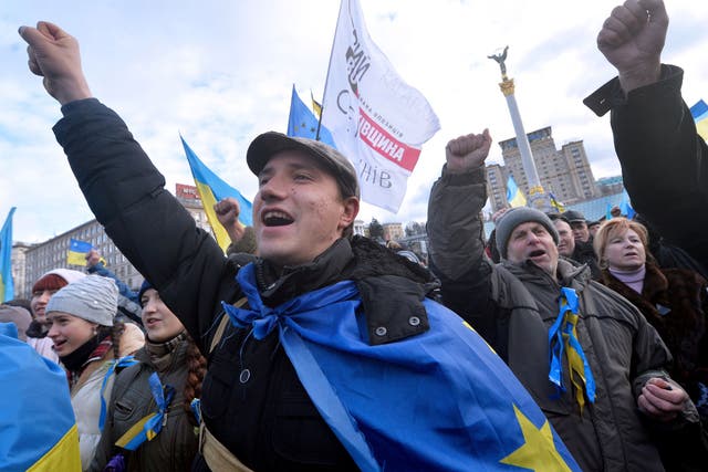 People shout slogans and wave flags of Ukraine and the European Union during a rally of the opposition on Independence Square in Kiev 