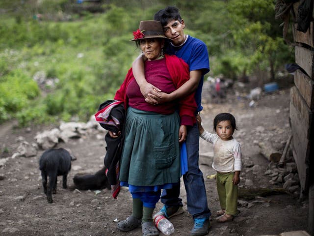 Aurelia Castro is embraced by her son Raul as his daughter stands by his side. Aurelia's first husband was killed in 1984 when the couple tried to escape from soldiers who accused villagers of collaborating with Shining Path rebels, Peru