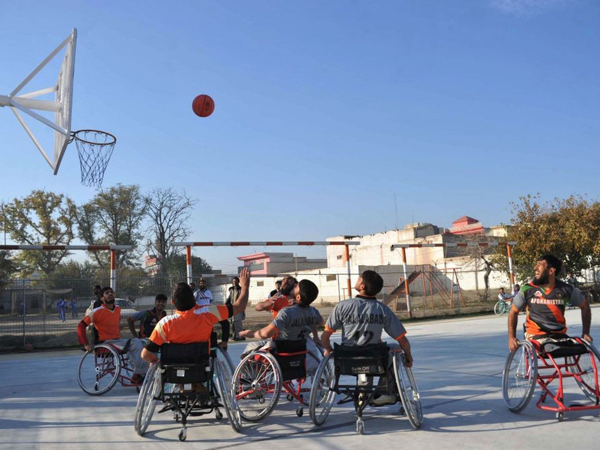 Afghan wheelchair basketball players take part in a match at a club for the disabled and victims of war, run by the International Committee of the Red Cross on the International Day of People with Disability in Jalalabad