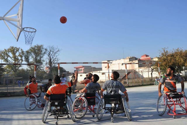 Afghan wheelchair basketball players take part in a match at a club for the disabled and victims of war, run by the International Committee of the Red Cross on the International Day of People with Disability in Jalalabad