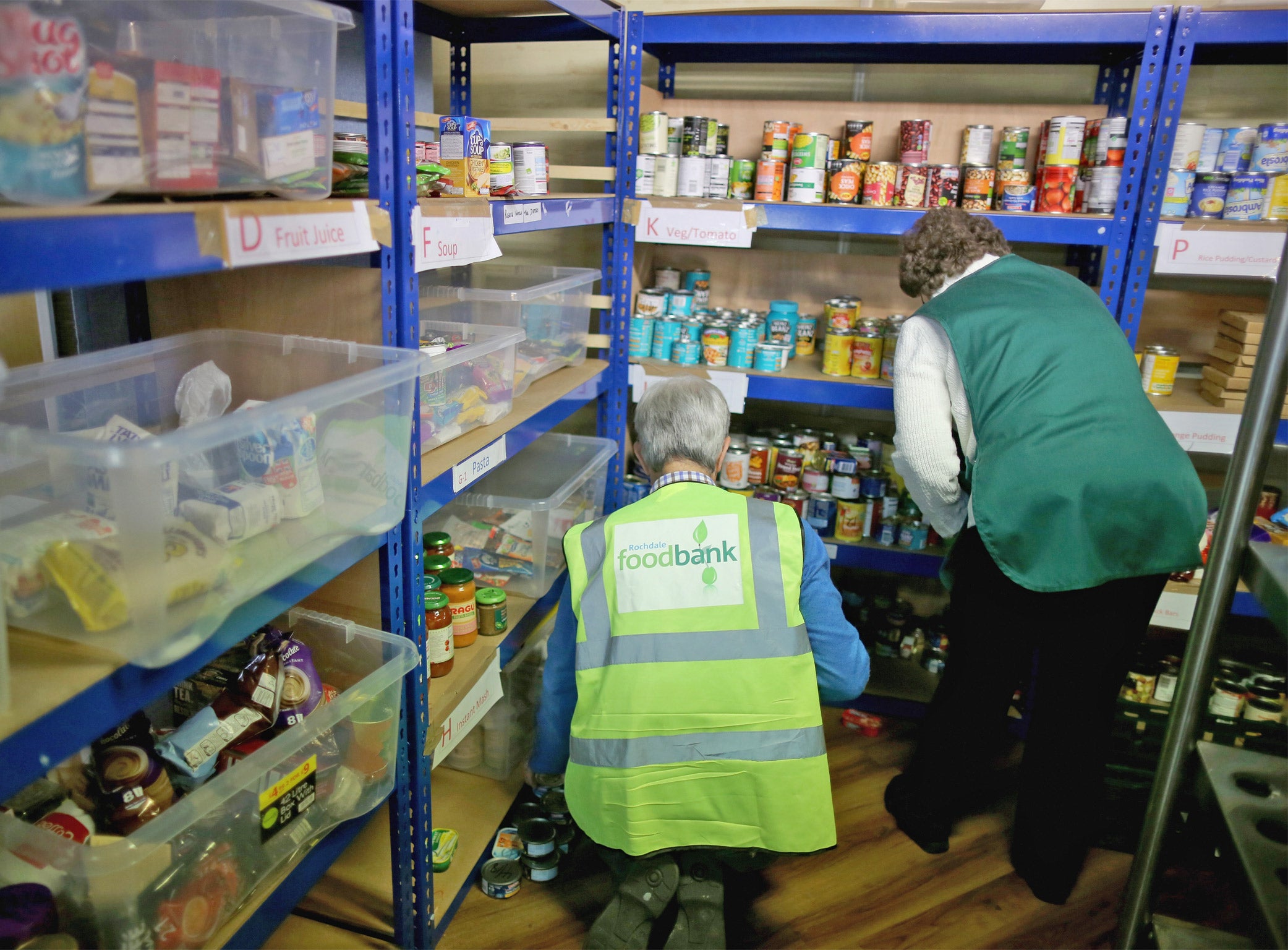 Volunteers sort through items of food at a Rochdale Foodbank