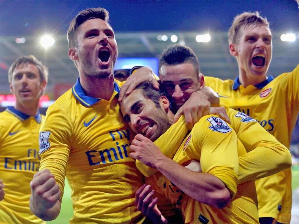 Arsenal players mob Mathieu Flamini after the midfielder’s goal at Cardiff