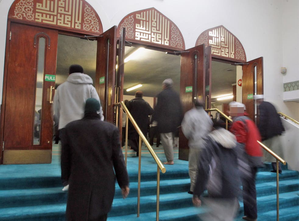 Muslim men attend prayer at the East London Mosque