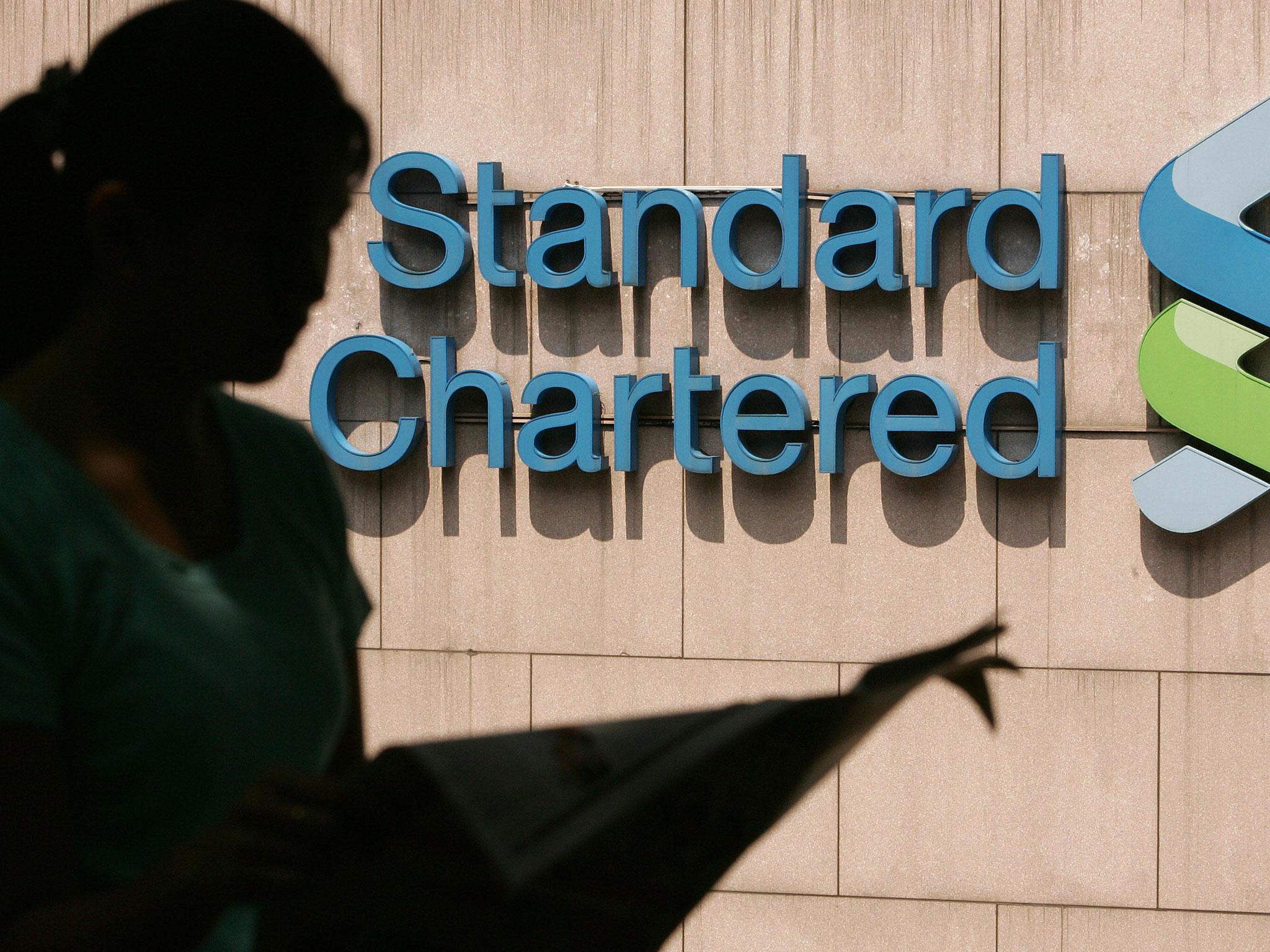 Standard Chartered has issued its first profit warning warns in a decade.