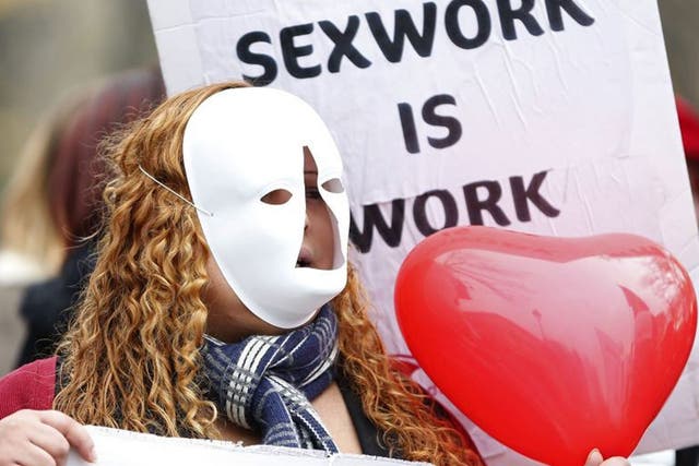 A sex worker activist attends a demonstration with prostitutes against a proposal to scrap sanctions on soliciting and instead punish prostitutes' customers with fines, Paris