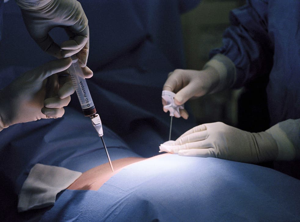 Surgeons performing bone marrow transplant on a patient