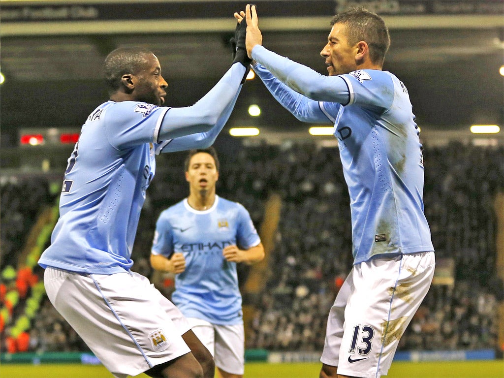 Yaya Toure celebrates with teammates after scoring City's second