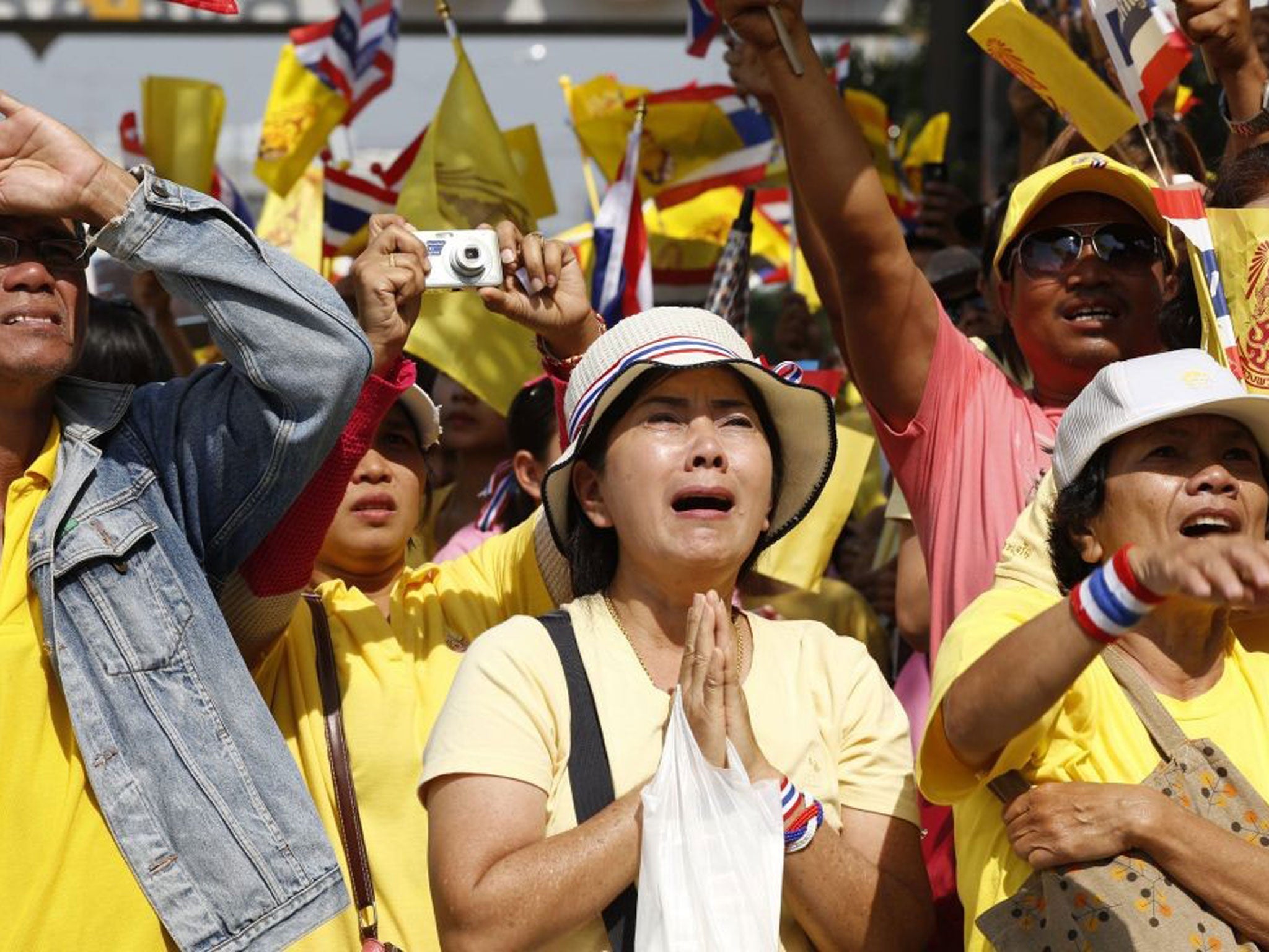 Thai people cry and cheer as they watch Thai King Bhumibol Adulyadej at Klai Kangwon Palace for celebrations on his 86th birthday, Thailand