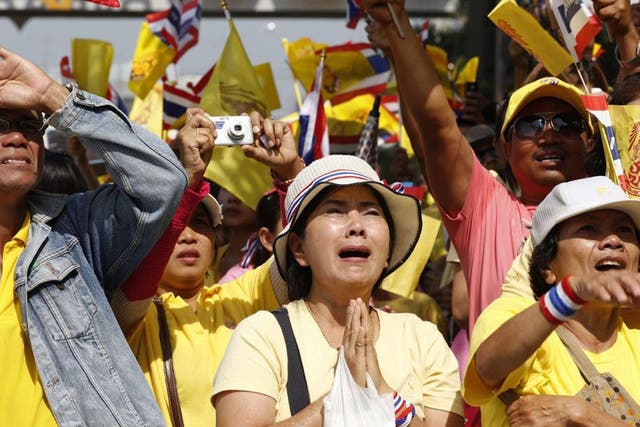 Thai people cry and cheer as they watch Thai King Bhumibol Adulyadej at Klai Kangwon Palace for celebrations on his 86th birthday, Thailand