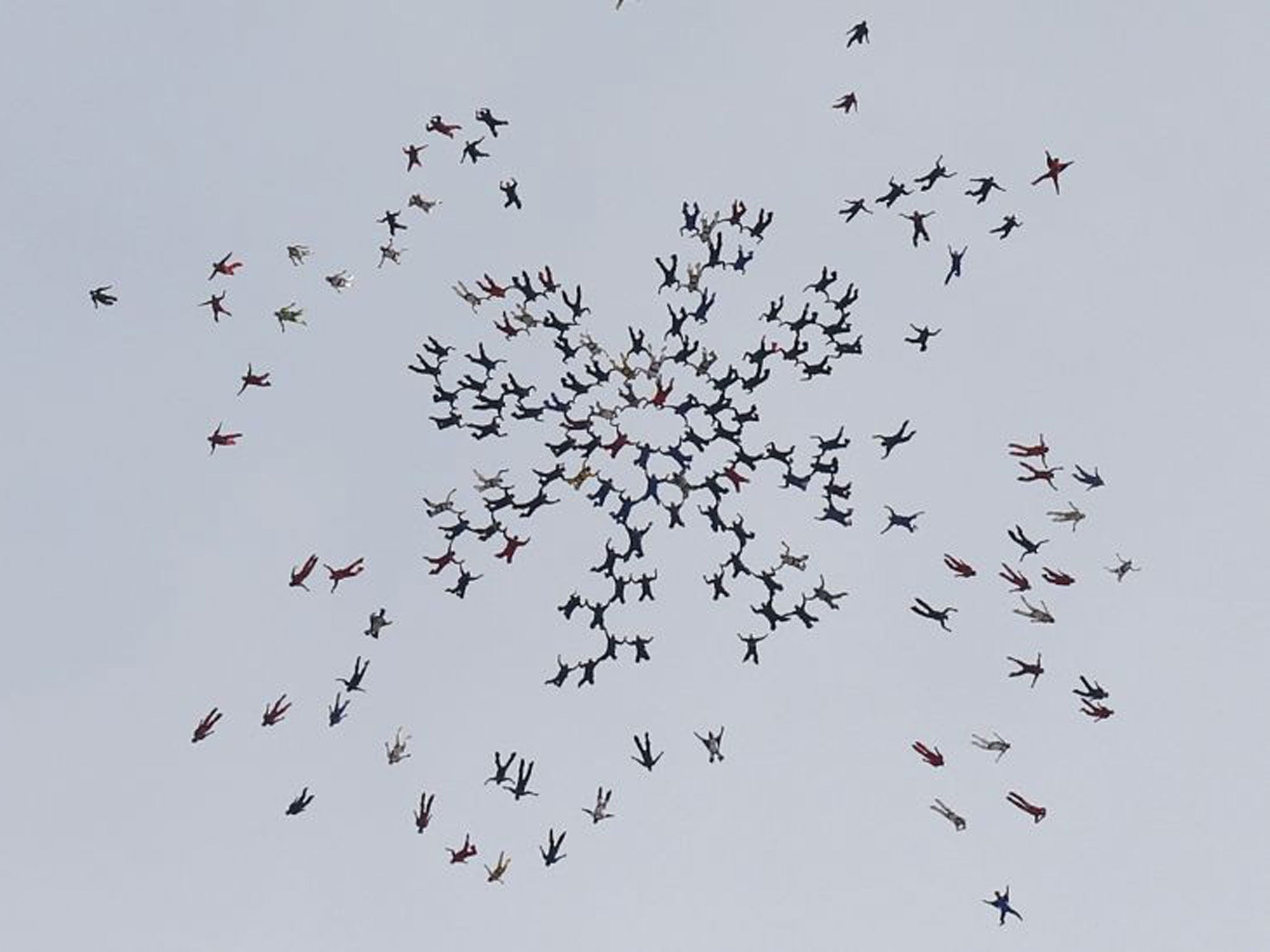 Skydivers, from all over the world, perform a group jump, the day after two skydivers were killed after colliding in midair during a jump from Skydive Arizona at Eloy Municipal Airport