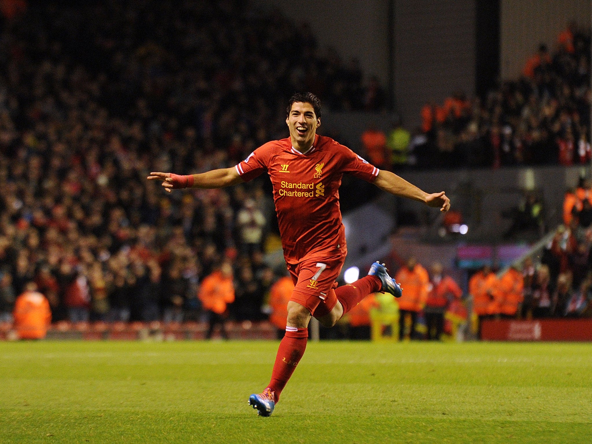 Luis Suarez celebrates after scoring four goals against Norwich