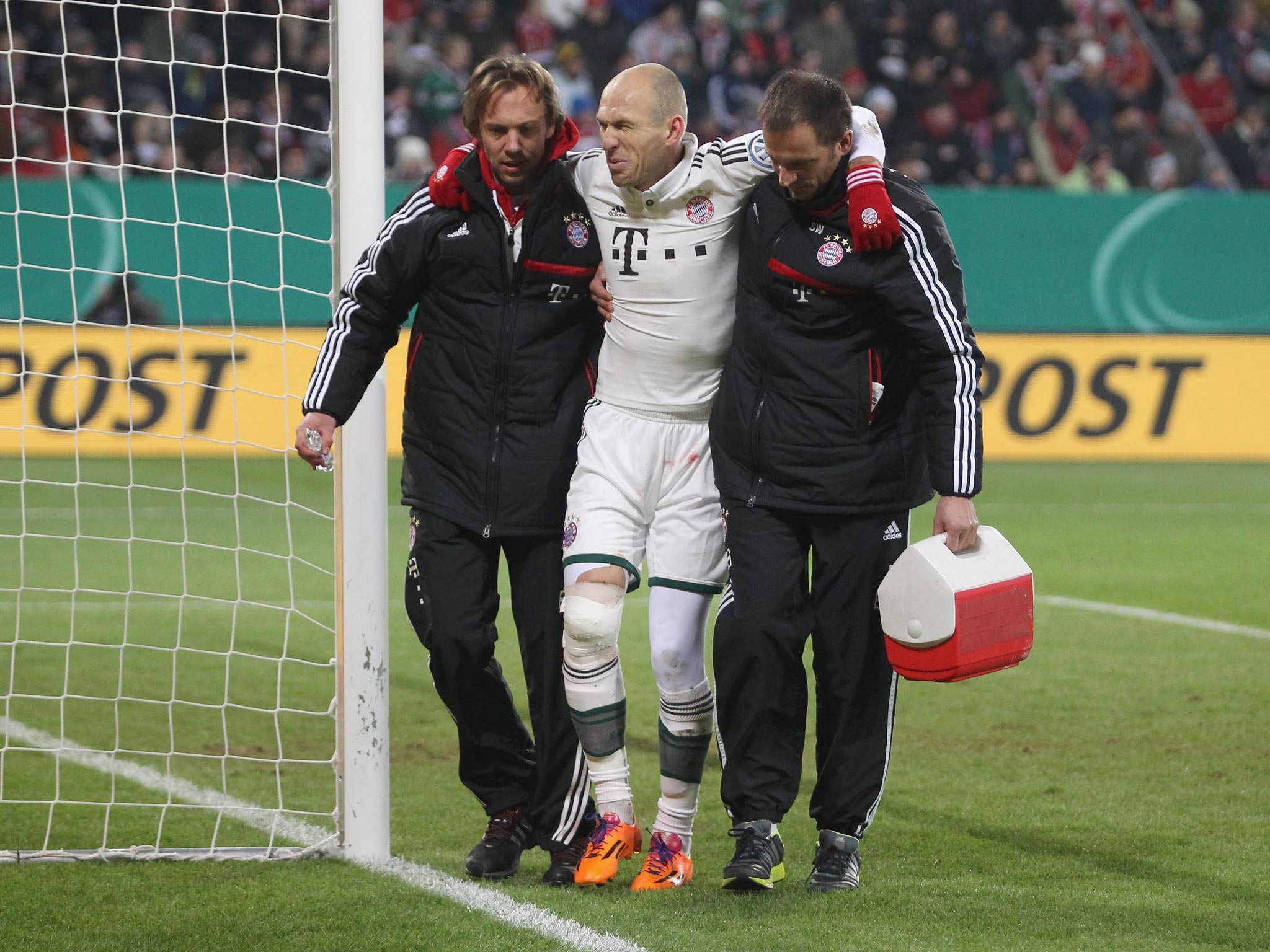 Arjen Robben is helped off the pitch