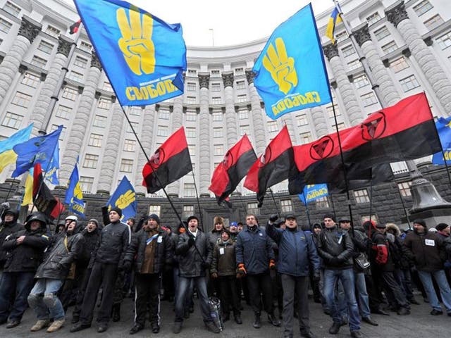 Pro-European demonstrators block the entrance of the Ukrainian ministers' Cabinet in Kiev. The United States urged Ukrainian authorities to heed the demands of thousands of pro-EU opposition demonstrators, as a senior minister said the government was ready to discuss snap elections