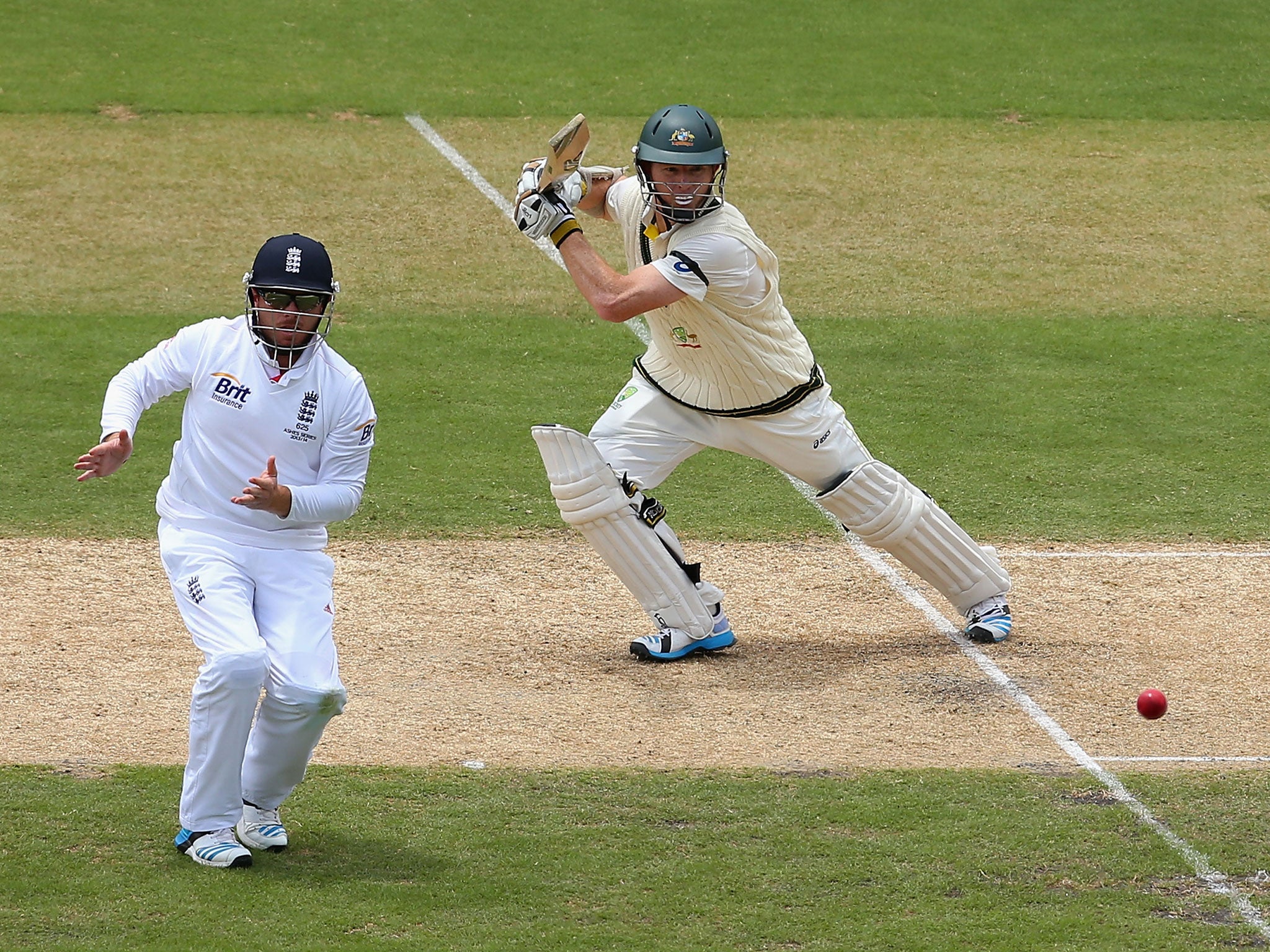 Chris Rogers hits a shot past Ian Bell on his way to 76