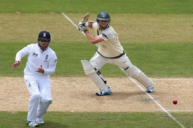 Chris Rogers hits a shot past Ian Bell on his way to 76
