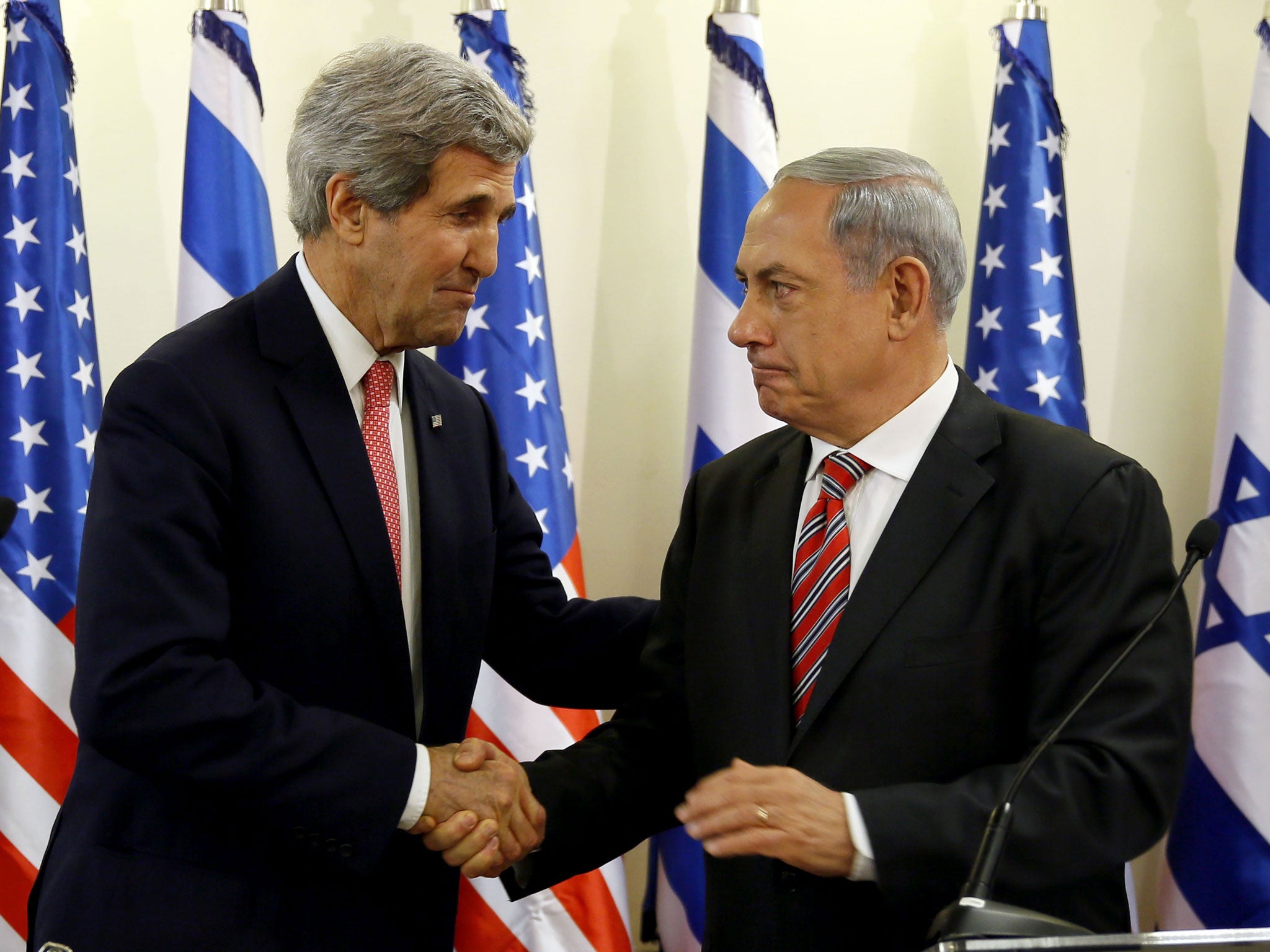 Israeli Prime Minister Benjamin Netanyahu shakes John Kerry's hand