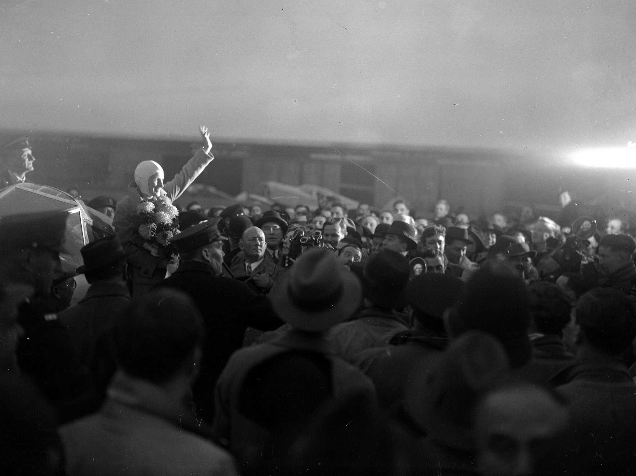 Amy Johnson is lifted above the crowds following her historic London-to-Cape Town flight