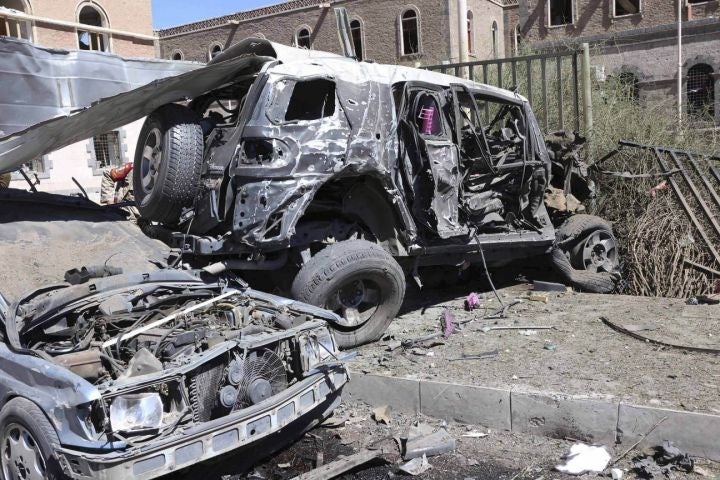 Damaged vehicles at the scene of a suicide attack at the Defence Ministry compound in Sanaa