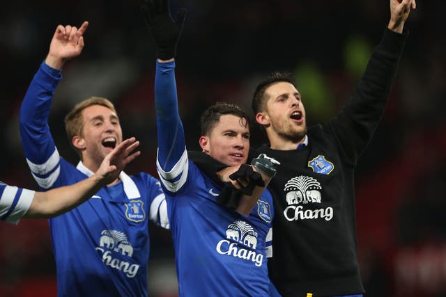Everton players celebrate their win over Manchester United after Bryan Oviedo's (C) late winner
