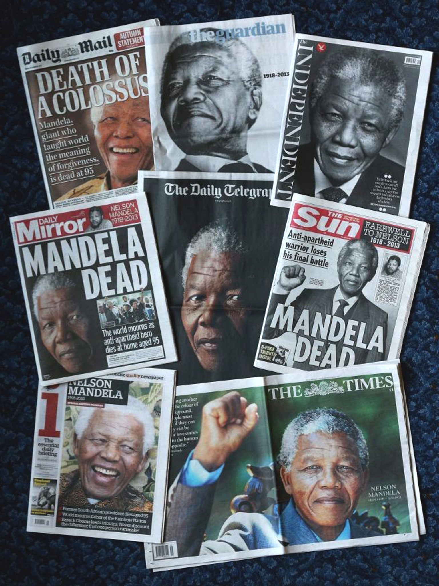 The front pages of British newspapers report on the death of former South African President Nelson Mandela in London, England