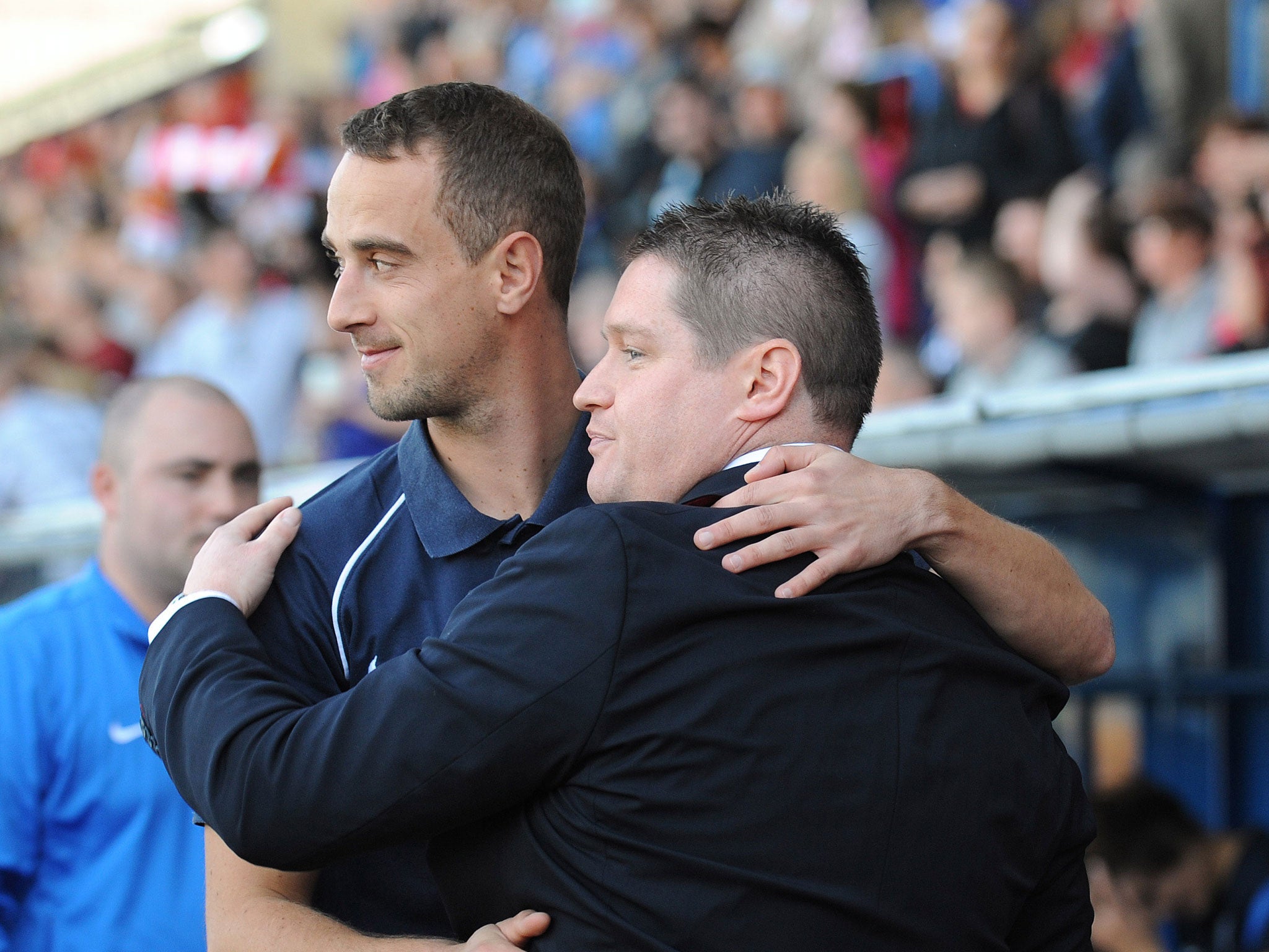 Mark Sampson, shown here sharing a hug with Liverpool Ladies manager Matt Beard, previously worked with Roberto Martinez at Swansea City's centre of excellence