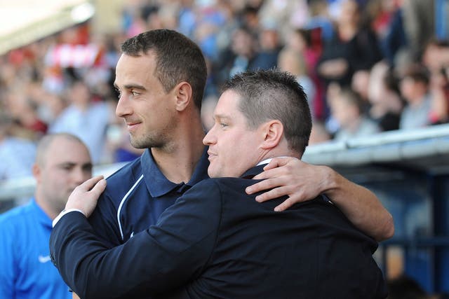 Mark Sampson, shown here sharing a hug with Liverpool Ladies manager Matt Beard, previously worked with Roberto Martinez at Swansea City's centre of excellence
