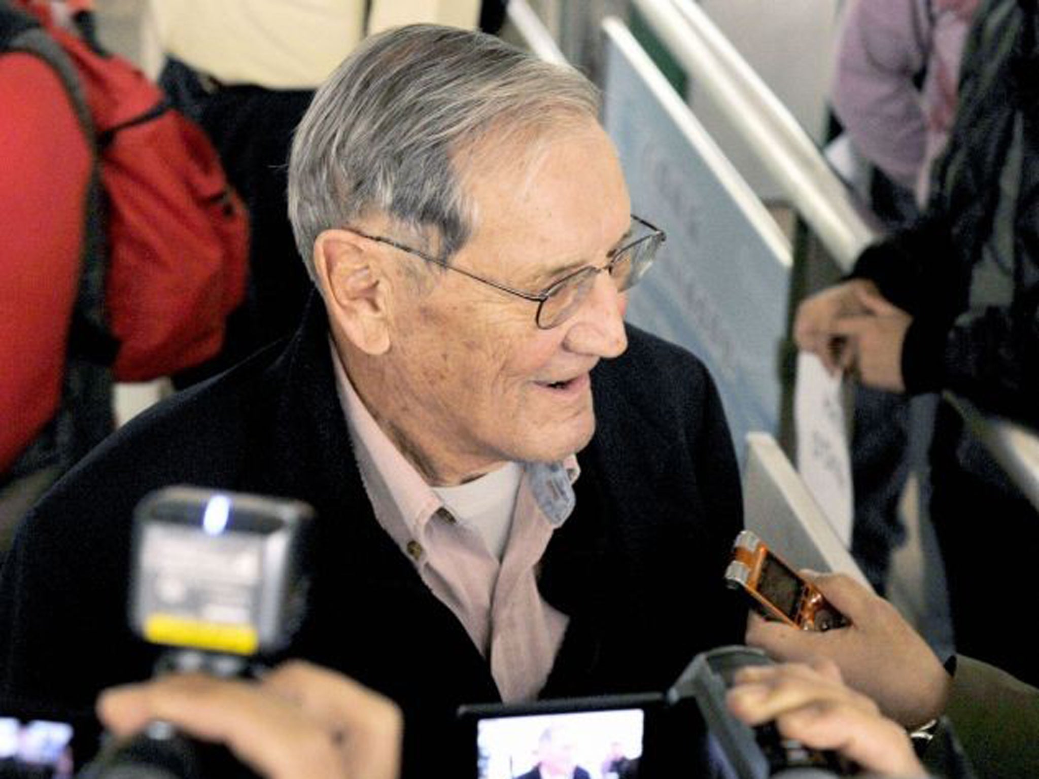 Merrill Newman speaks with reporters after landing in Beijing