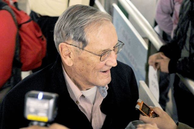 Merrill Newman speaks with reporters after landing in Beijing