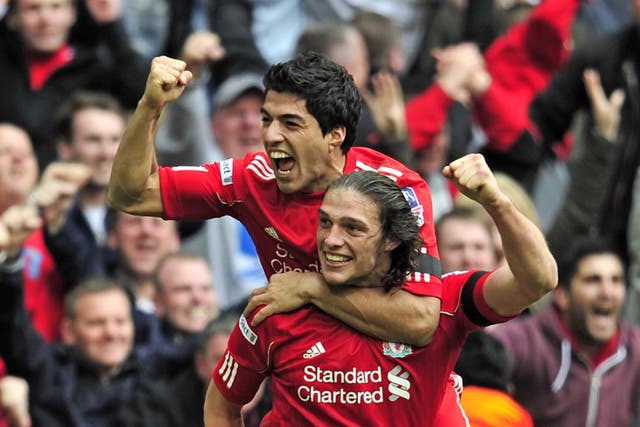LIttle and large: Andy Carroll and Luis SUarez were both wigned for Liverpool in January 2011 after the sale of Fernando Torres