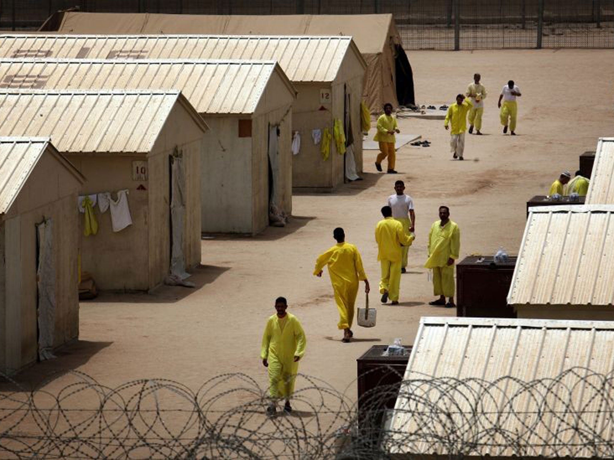 Iraqi detainees at Camp Bucca, run by US and British forces; a Red Cross report details abuse of prisoners there