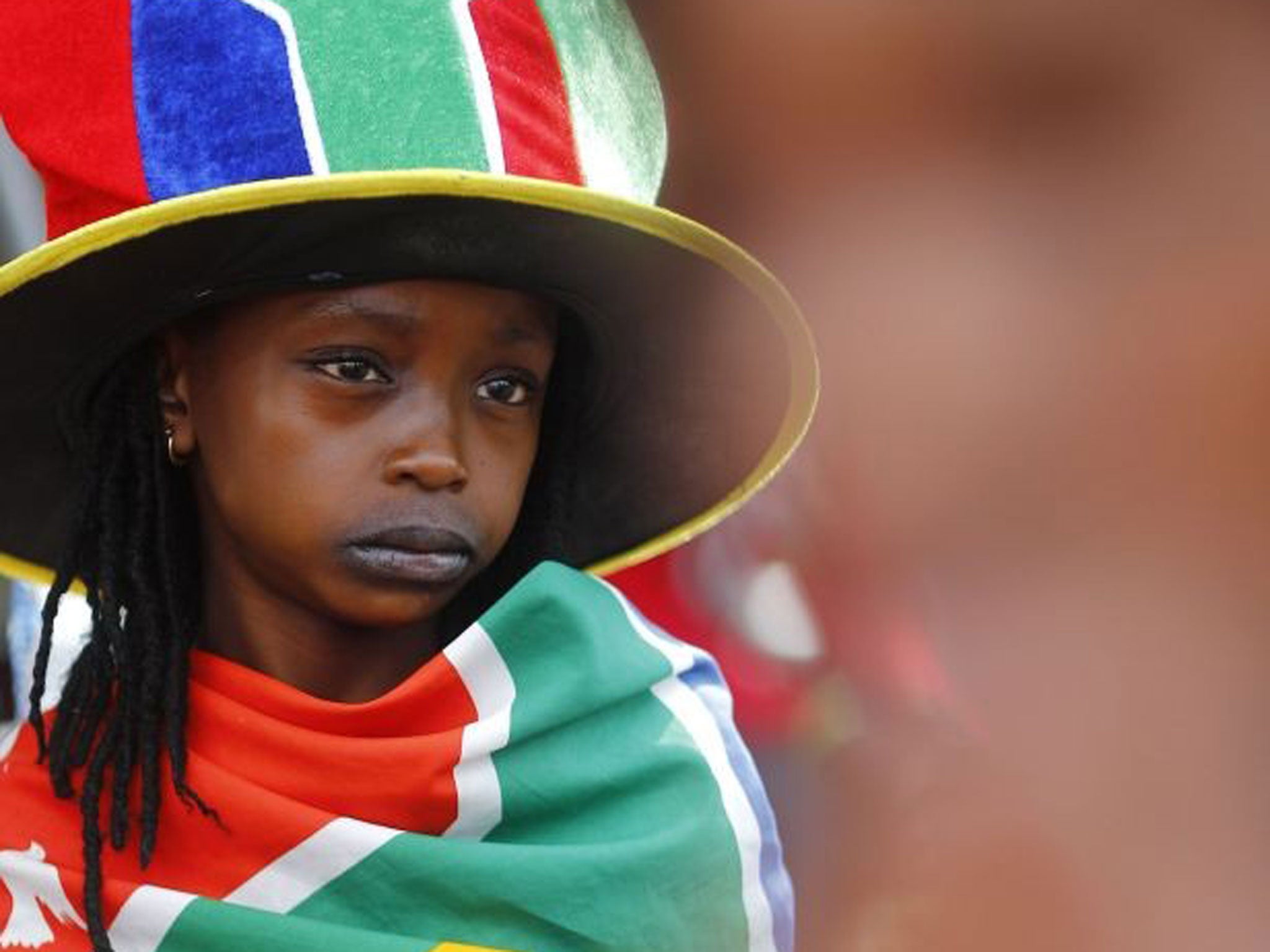 Tributes: A child in patriotic garb outside Mandela’s former home in Soweto