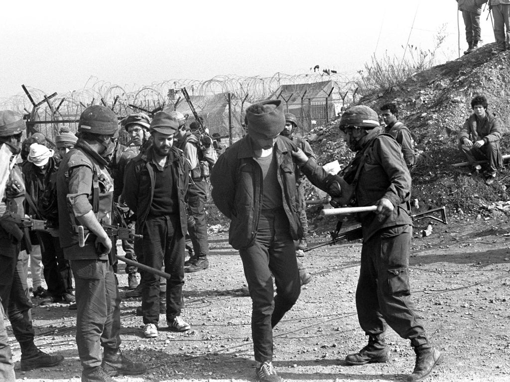 In this archive image provided by the Israeli Government Press Office (GPO), during Israel's Lebanese war, Israeli soldiers check the identity of Lebanese prisoners before they leave an Israeli military prison on their release from Ansar detention camp Ap