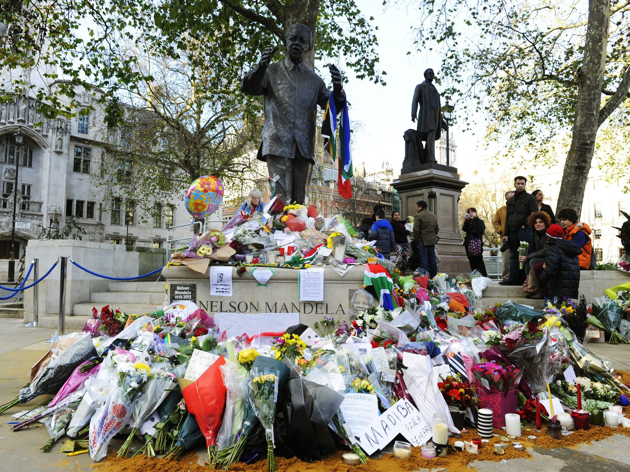Mandela’s statue in London’s Parliament Square, adorned with flowers, messages and a flag